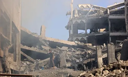 Emergency responders at the scene of an Israeli airstrike in Gaza where a senior police official was reportedly killed.