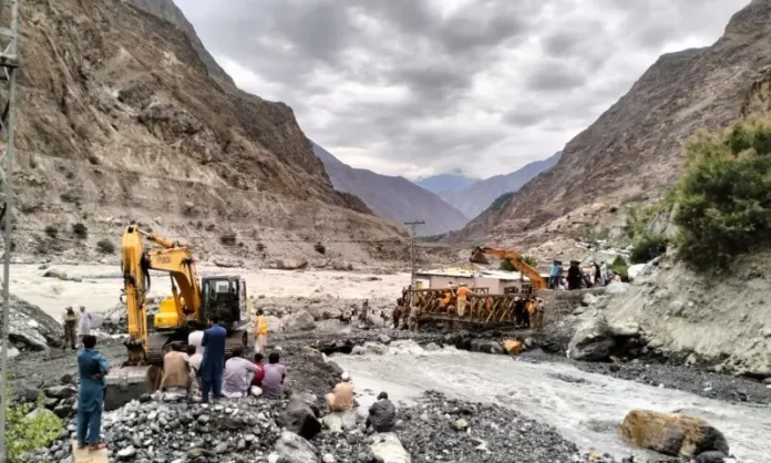 A landslide blocks a mountain highway in Gilgit-Baltistan as floodwaters surge through a valley following heavy rainfall and a GLOF warning