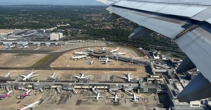 Passengers walk through London Gatwick Airport as airport staff respond to a water supply disruption affecting terminal facilities