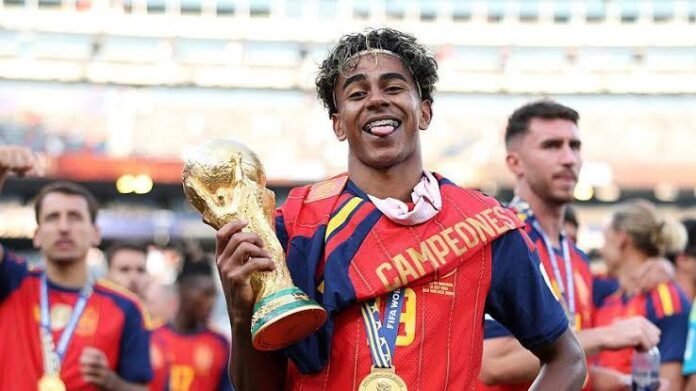 Lamine Yamal: The Boy Who Turned His Mother’s Sacrifice Into History Lamine Yamal celebrates Spain's FIFA World Cup victory while honoring the journey from his humble childhood to becoming one of football's brightest stars.