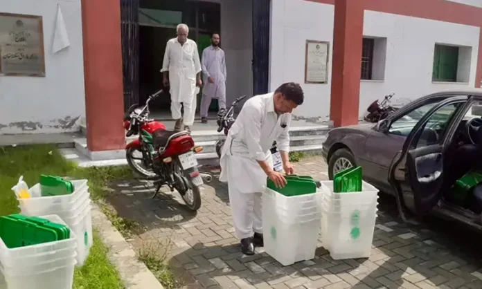 Voters casting ballots at a polling station during the second phase of Azad Jammu and Kashmir local government elections in Muzaffarabad division.