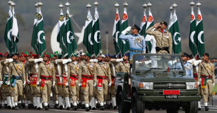 Pakistani and Turkish military personnel at a joint Defence Day celebration with Pakistan and Türkiye flags