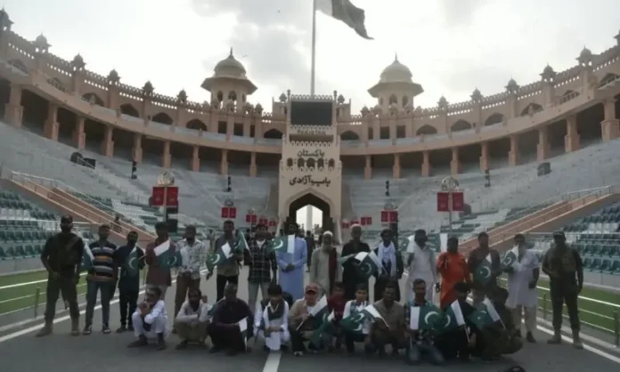 Pakistani nationals return home through the Wagah border after their release from Indian jails.