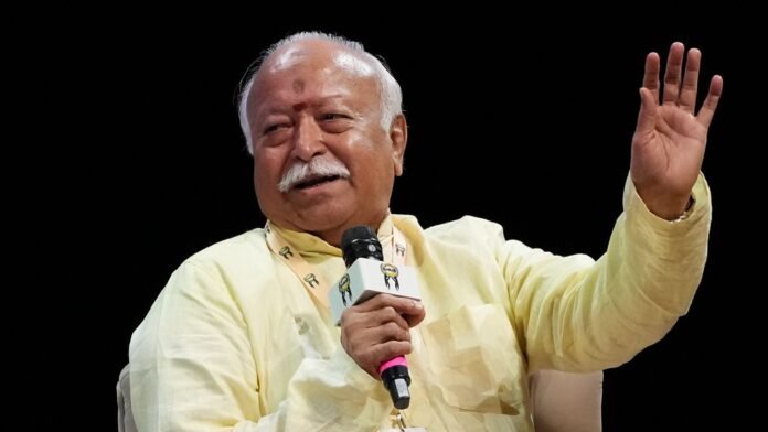 RSS chief surrounded by reporters during questions about minority rights and human rights concerns in India.