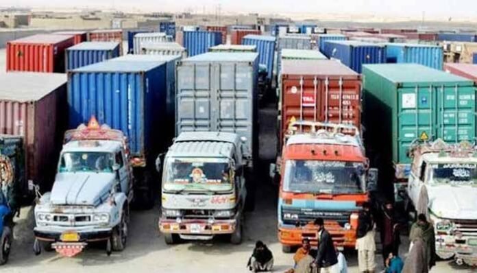 Goods trucks and containers parked in Karachi amid concerns raised by transporters